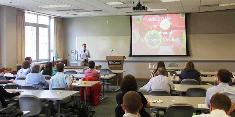 WSLH Virology Laboratory and Surveillance Team Leader Erik Reisdorf greets conference attendees.