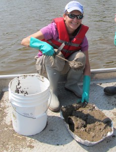 WSLH Environmental Toxicologist Camille Turcotte scoops up sediment samples for testing.