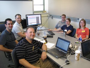 Around the table from bottom left are Nick Beckloff (GenoLogics), Thomas Stark (CDC Influenza Division), Rob Hall (GenoLogics), Rich Griesser and Tonya Danz (WSLH) and Stephanie Chester (APHL).