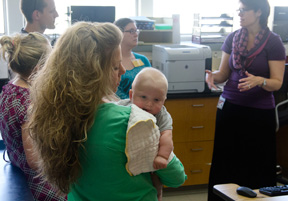 Wisconsin Newborn Screening Laboratory Co-Director Dr. Patrice Held (right) explains what happens in the lab to Kristi Schrimpf holding son Logan, Waisman Center dietitian Therese Breunig, David Schrimpf and Joelle Odor.