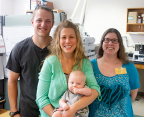 David, Kristi and Logan Schrimpf and Joelle Odor in the Wisconsin Newborn Screening Laboratory. Joelle was the first baby to test positive for PKU after newborn screening was consolidated at the WSLH in 1978. Logan is one of the most recent babies to test positive for PKU.