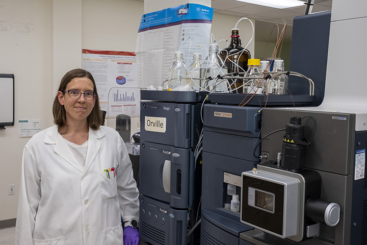 Heather Barkholtz, PhD, assistant professor in the University of Wisconsin-Madison School of Pharmacy and Wisconsin State Laboratory of Hygiene (WSLH) stands in the WSLH Forensic Toxicology laboratory where testing is performed for some of her research.